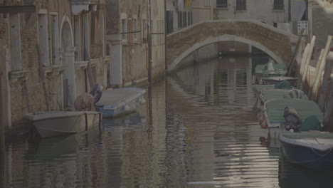venice canal with boats and buildings