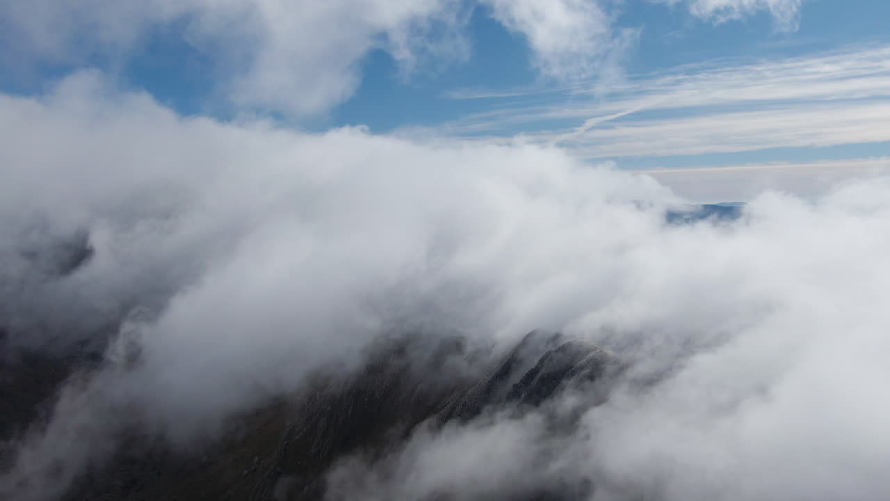 Aerial View of Mountains Covered in Clouds