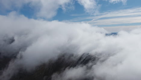aerial view of mountains covered in clouds
