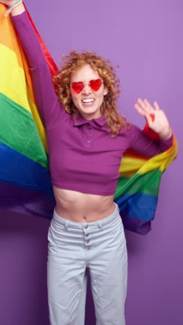 woman celebrating pride with rainbow flag