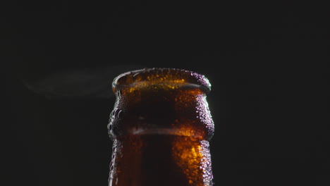 Close-Up-Of-Condensation-Droplets-On-Neck-Of-Revolving-Bottle-Of-Cold-Beer-Or-Soft-Drink-With-Water-Vapour-After-Opening