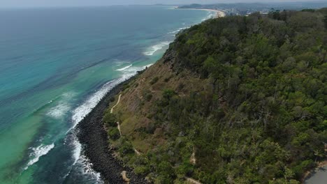 Volando-Hacia-Atrás-El-Parque-Nacional-Burleigh-Heads,-Olas-Rompiendo-Un-Brillante-Día-Soleado,-Pista-Para-Caminar-Debajo