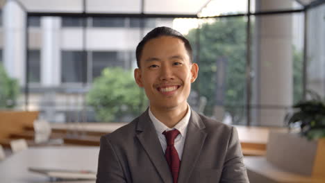 young asian businessman walking into focal plane