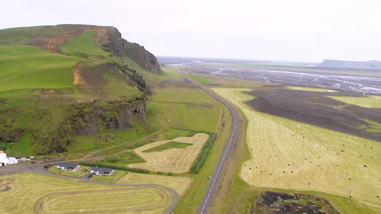 Aerial view of vast Icelandic landscape with fields and mountains