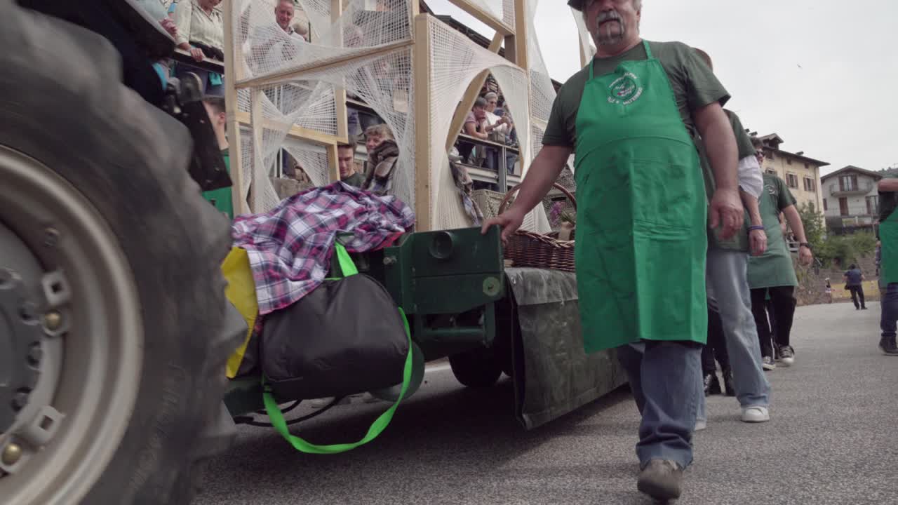 Tractor pulling a parade wagon at the annual Grape Festival, Verla di Giovo, Trentino, Italy