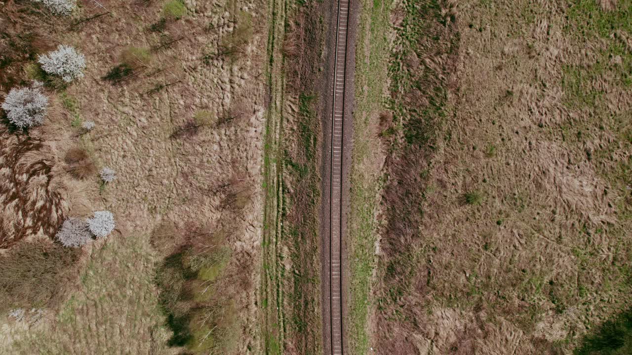Tracking drone shot, looking down at railway tracks