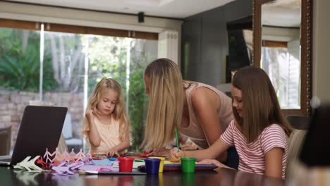 mother and daughters painting together