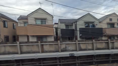 passing city buildings and homes from train view