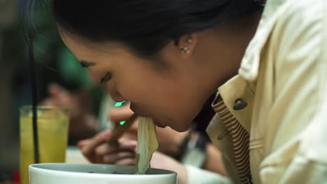 Handheld-view-of-Vietnamese-couple-eating-pho-soup