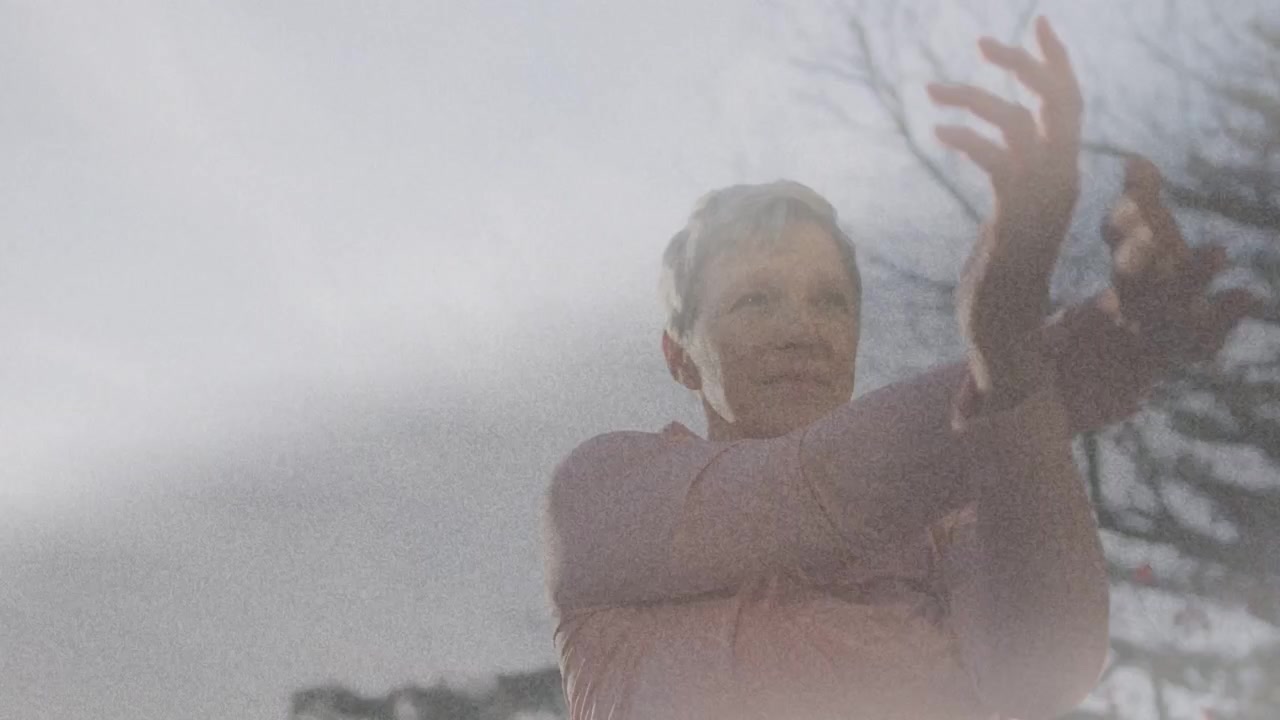 Woman starting warm-up, reaching arms, crossing forearms and rotating wrists for health under sun