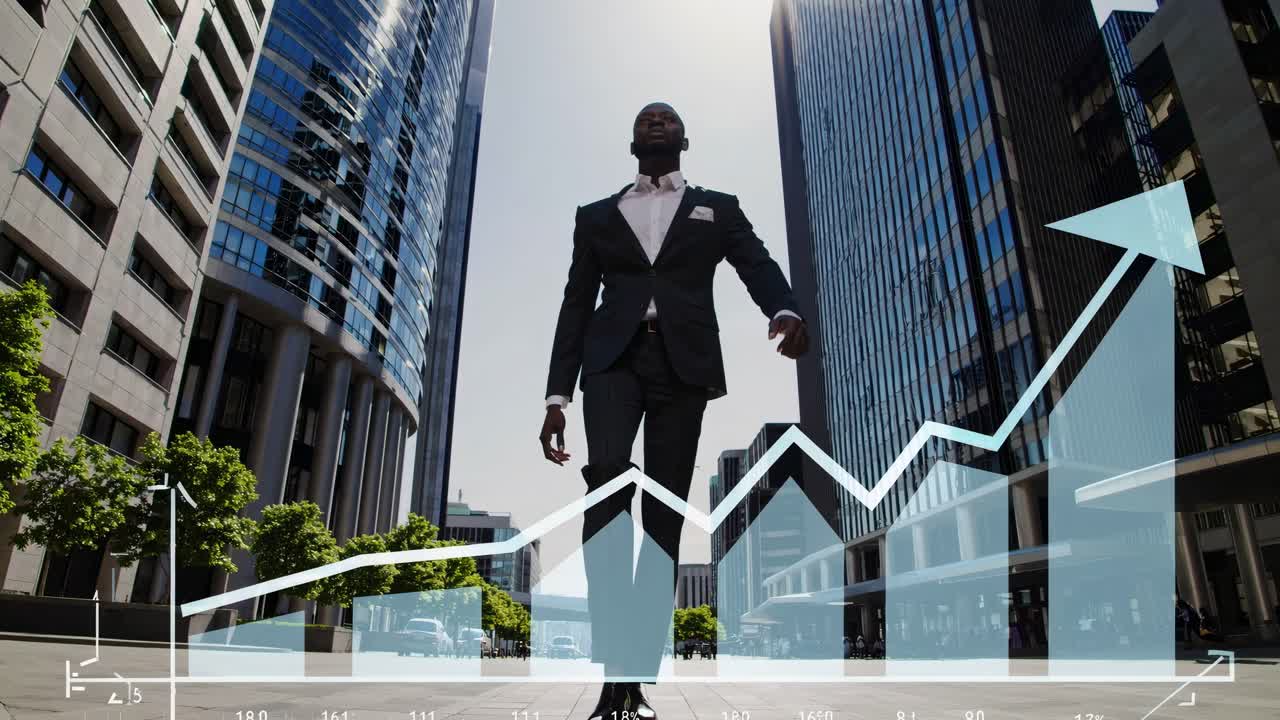 Low-angle video of a confident man in a suit walking between skyscrapers, with a dynamic upward
