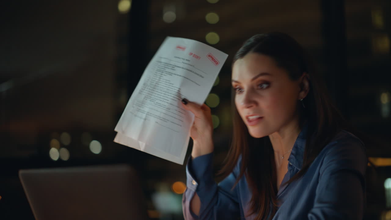 Annoyed boss arguing video meeting at night workspace closeup. Angry woman