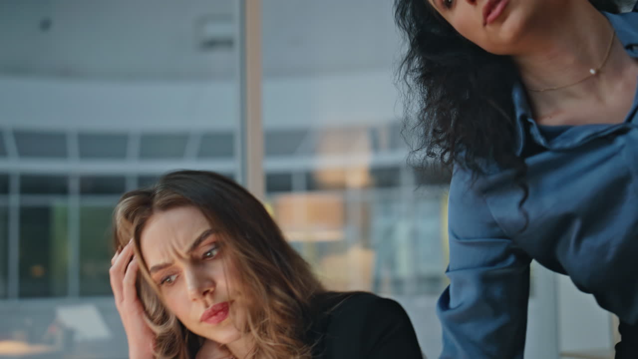 Two colleagues reviewing data in evening. Closeup focused managers solve problem