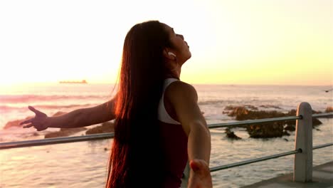 sporty woman with arms raised