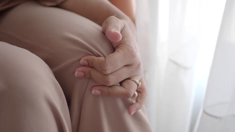 Close up of a woman's hand with a ring on her finger