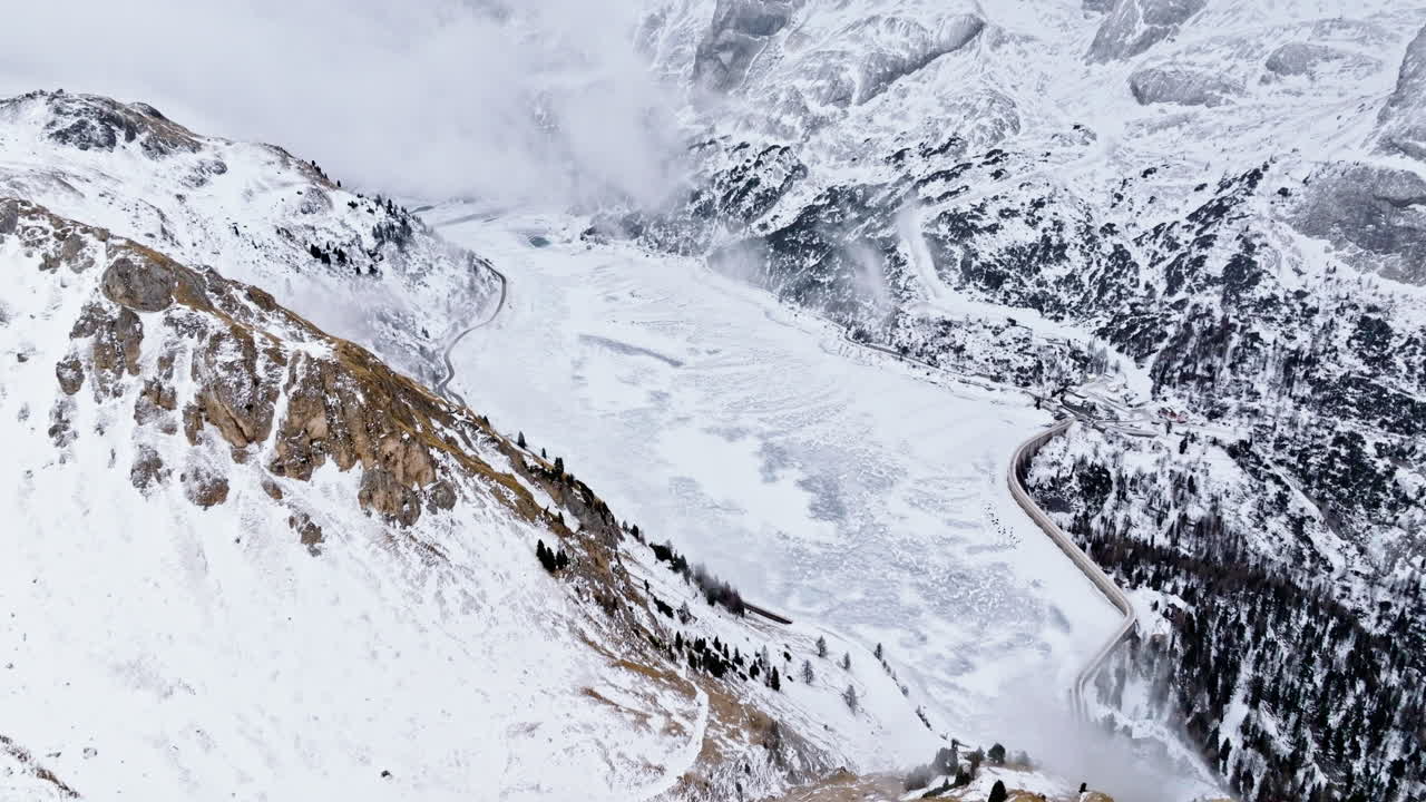Aerial drone view of Portavescovo covered in snow, in Arabba, Italy