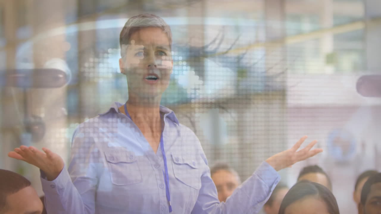 Businesswoman presenting data processing animation over diverse audience in office