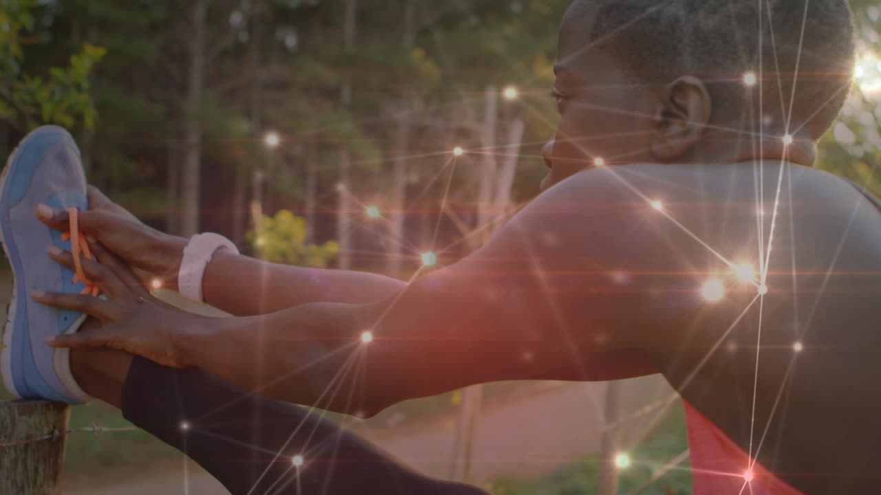 Animation of network of connections over woman stretching exercising in forest