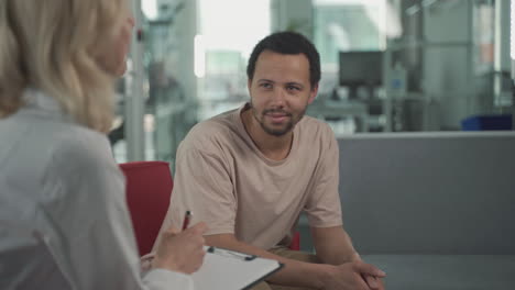 a young black man listening to a female doctor