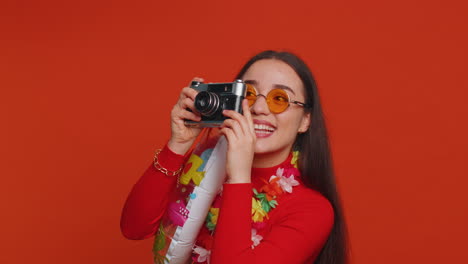 Happy-young-woman-tourist-photographer-taking-photos-on-retro-camera-and-smiling,-holiday-vacation