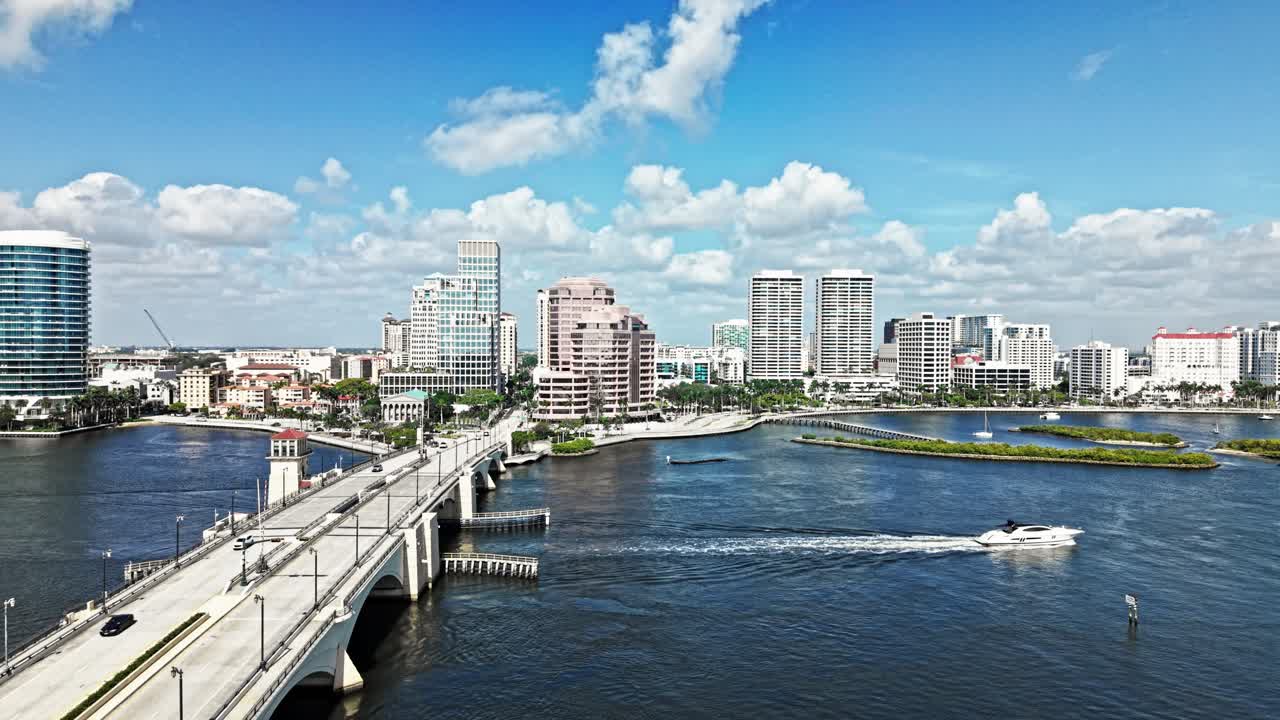 Aerial: Royal Park Bridge with One Flagler and Phillips Point building in West Palm Beach, Florida, USA, crane down drone shot