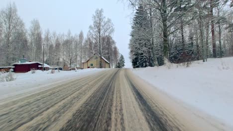 winter pov driving on snow and icy country road rural environment finland