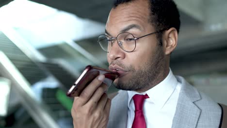 Serious-businessman-talking-by-cell-phone