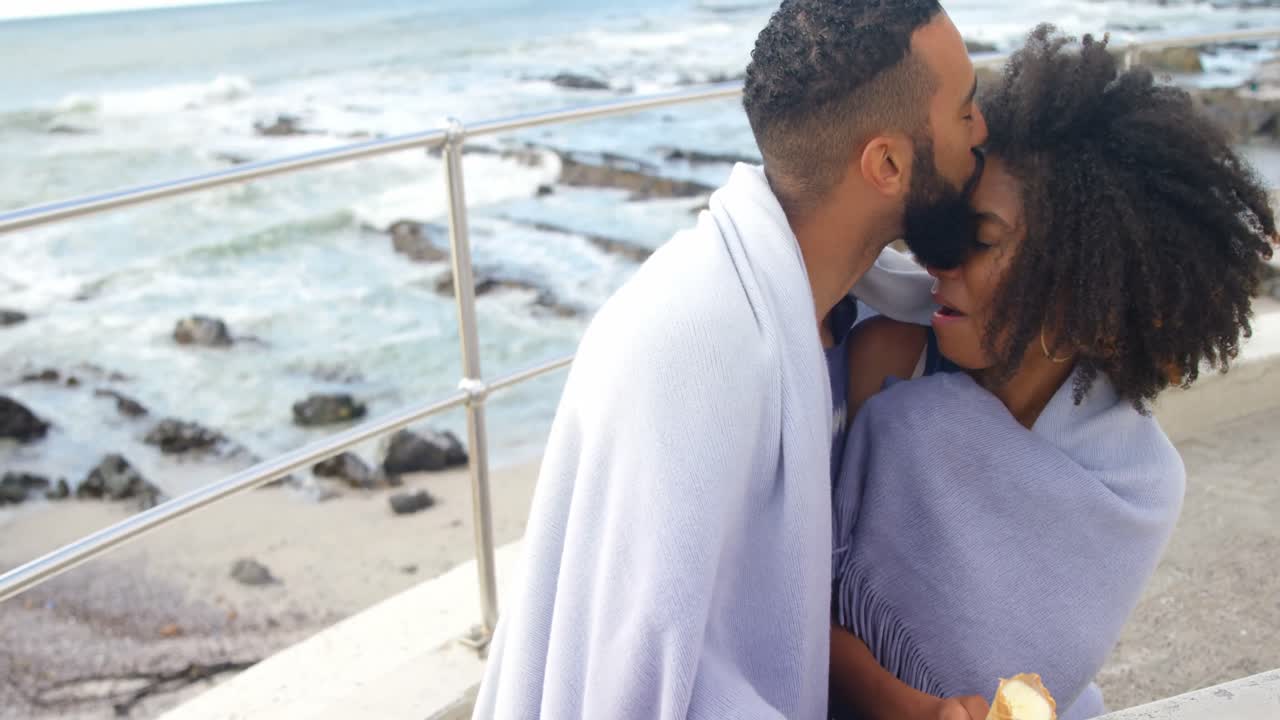 Couple having ice cream cone at beach 4k