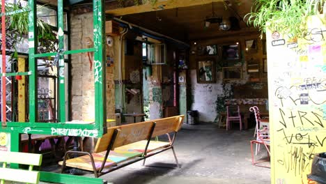 view of the historic ruin bars in the heart of budapest in hungary, europe - pubs built in graffiti covered abandoned and war torn spaces - smooth panning left 4k 30fps