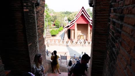 people entering and exiting a historic temple