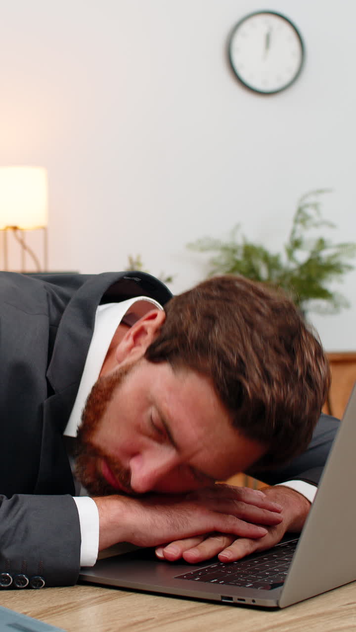 Middleaged businessman exhausted types report falls asleep on laptop keyboard face down during work