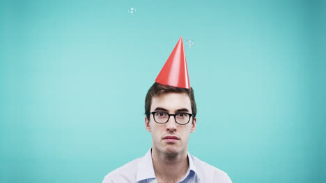 Single-man-is-sad-in--bubble-shower-slow-motion-photo-booth-blue-background