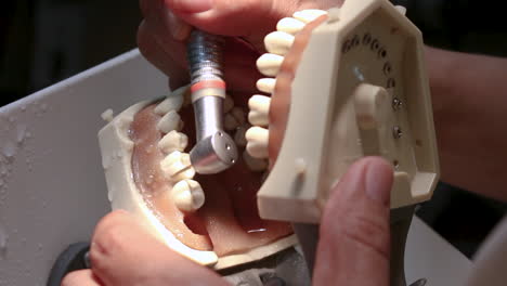 dentist dental turbine practicing on a dental training model, close up