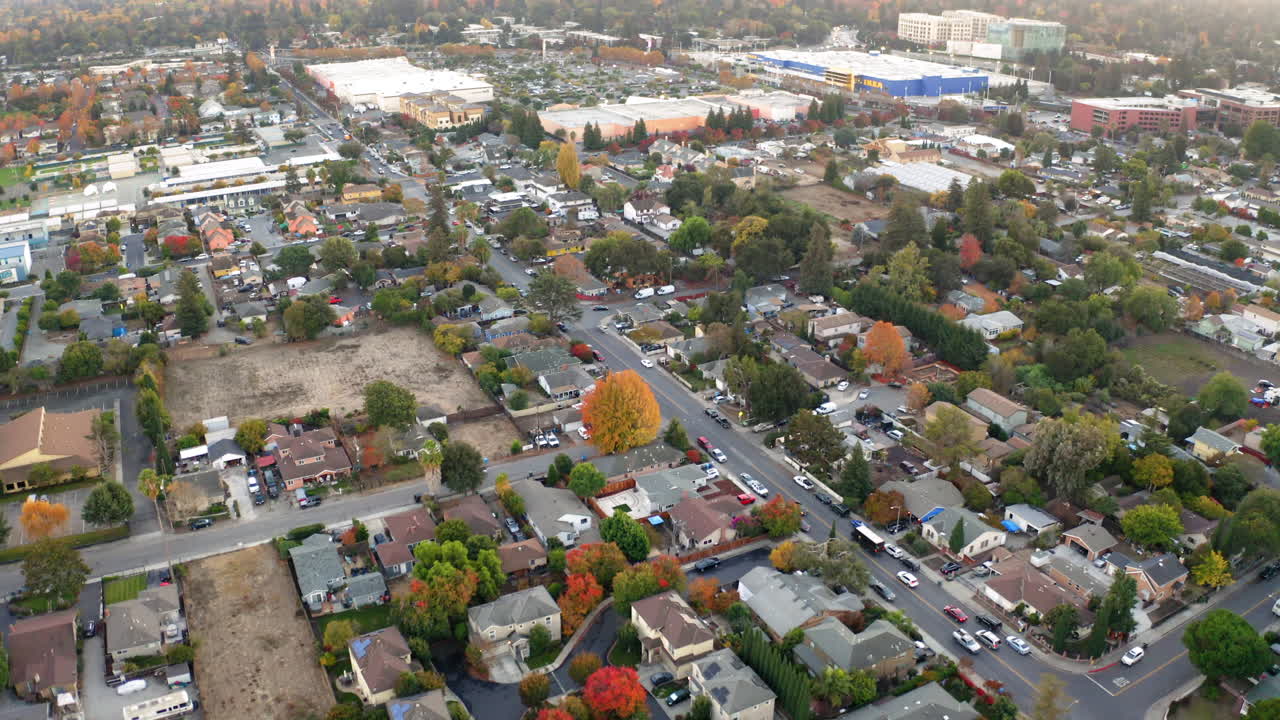 Aerial View of a Suburban Neighborhood with Autumn Foliage and Commercial Buildings