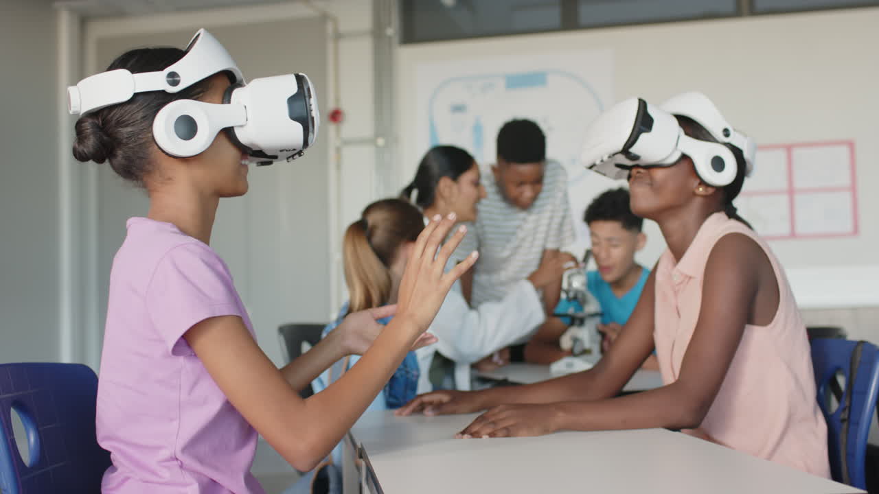 Using VR headsets, students exploring virtual reality in school classroom
