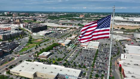 american flag proudly flies over urban city in usa