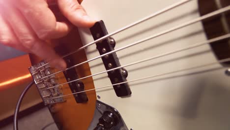 person playing bass guitar close-up