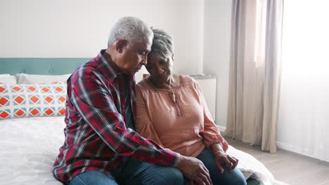 Senior-Man-Comforting-Woman-With-Depression-In-Bedroom-At-Home