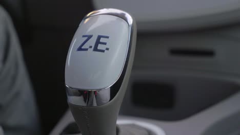 driver's hand shifting gearstick knob of a renault zoe car