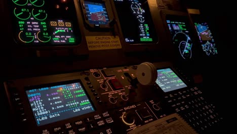 exclusive night view of a jet cockpit during a night flight while copilot selects landing gear lever down