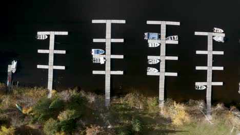 top down dolly right of recreational boats parked sporadically at their docks