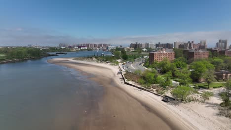 an aerial view over the beach on gravesend bay in brooklyn, ny on a beautiful day with blue skies and white clouds