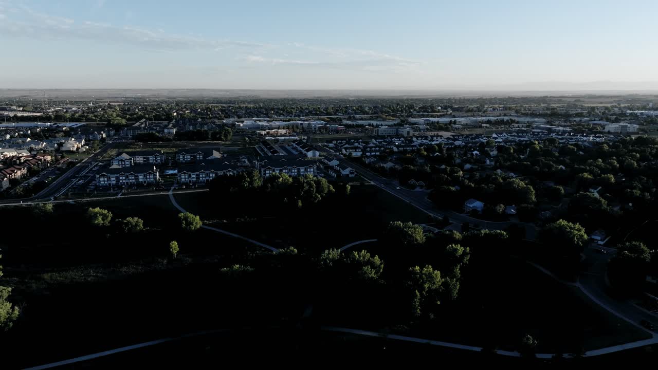 Greeley Colorado west side of town establishing shot from a 4k drone. Long shadows cinematic golden hour.