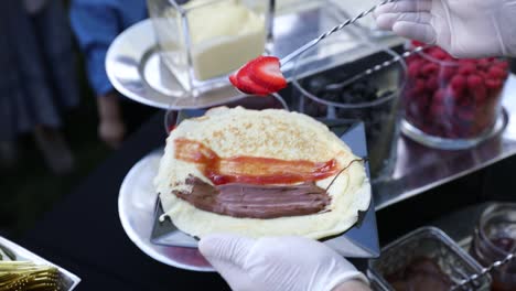 filling crepe with strawberry slices