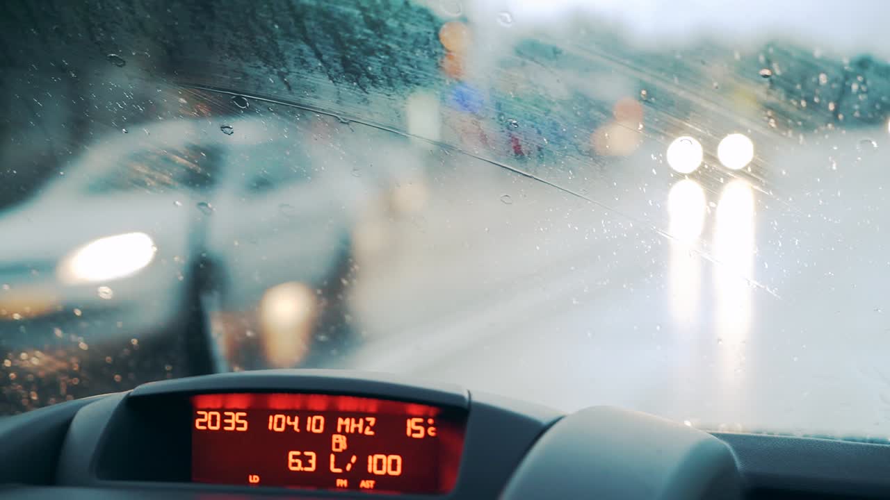 Windshield wipers work during heavy rains. Car dashboard. Close-up
