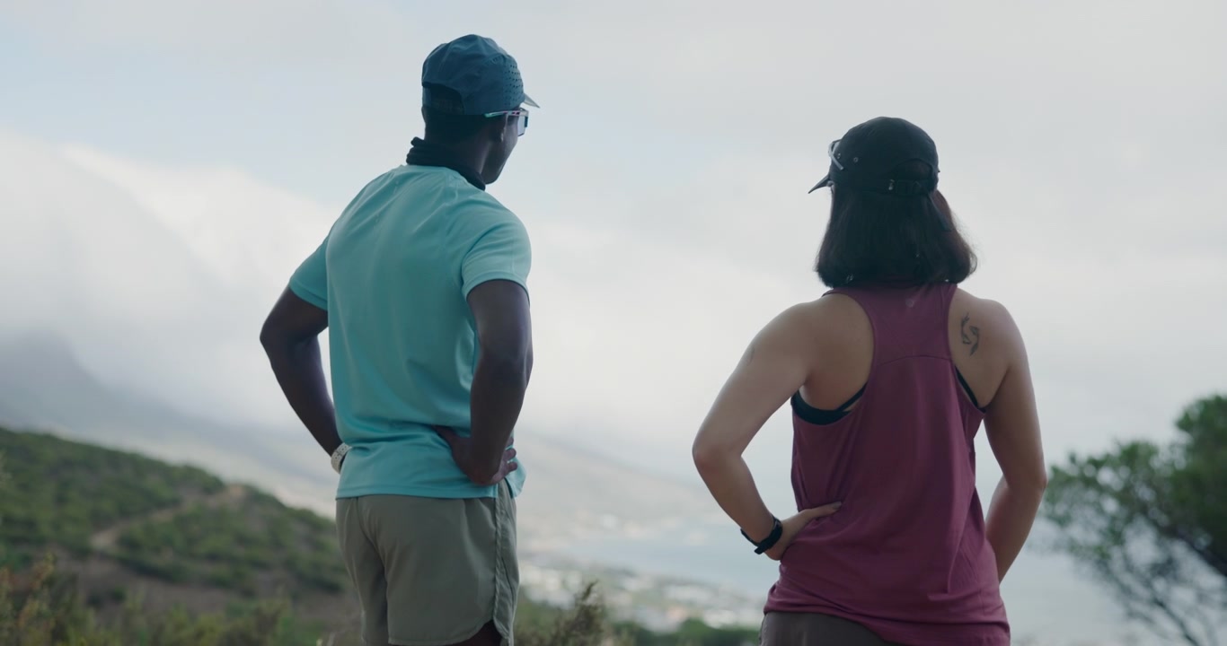 Couple Standing on Hilltop Overlooking Coastal Landscape