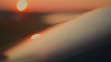 Car windshield lit by sunset light closeup mirror surface of modern auto window at red twilight sun