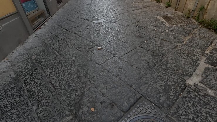 A narrow, cobblestone street in Naples