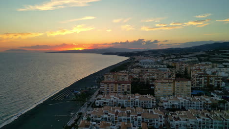 golden hour over coastal hotels in malaga: high-reversing drone view