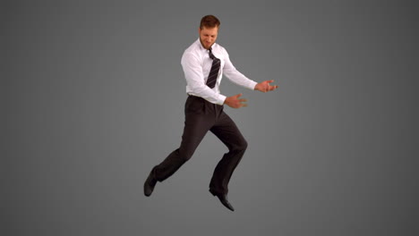 businessman leaping on grey background